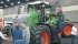 Agco’s Reid Hamre, left, discusses the new Fendt 900 series tractor with Kentucky farmers Tom and Allen Skinner during the National Farm Machinery Show. “The Fendt has many features that are optional on competing machines ... with much better resale values.” | Michael Raine photo