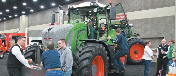 Agco’s Reid Hamre, left, discusses the new Fendt 900 series tractor with Kentucky farmers Tom and Allen Skinner during the National Farm Machinery Show. “The Fendt has many features that are optional on competing machines ... with much better resale values.”  |  Michael Raine photo