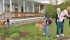 Yvonne Brown, centre, takes her great-granddaughter, Sarah, from Siobhan Brown while Sheryl Brown picks weeds in the garden at Katepwe Farms. | Christalee Froese photo