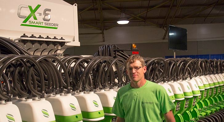 Colin Rosengren, VP agronomics of Clean Seed Agricultural Technologies, stands in front of the 60-foot drill on display at the 2014 edition of Canada''s Farm Progress Show in Regina, Saskatchewan. | Robin Booker, photo.