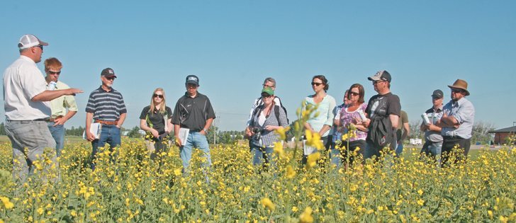 Ken Coles, left, of Farming Smarter tells participants at the June 24 Lethbridge field school about spraying trials that explore the effectiveness of herbicides when applied in the morning, midday and midnight.  |  Barb Glen photo