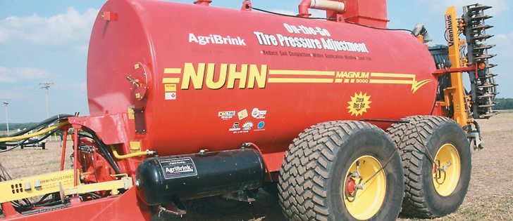 Ontario hog farmer Jake Kraayenbrink hauls millions of slurry gallons every year and was frustrated by having to wait at the field edge for the big flotation tires to inflate and deflate each time — the tires needed 40 p.s.i. for transit and 20 p.s.i. or less in the field. | Ron Lyseng photo