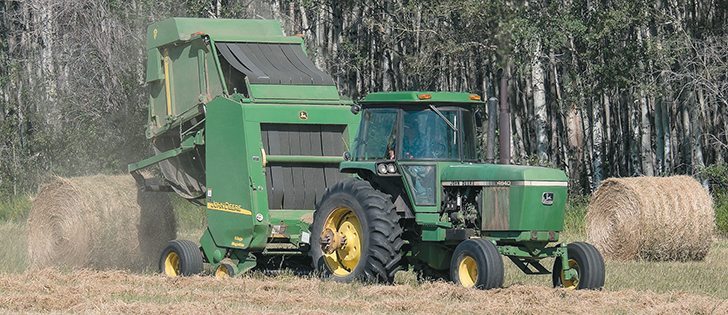Baling was underway in a field northwest of Woking. The hot, dry weather has been good for haying, but has been tough on crops, especially canola and peas. | Randy Vanderveen photo.