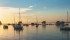 The setting sun highlights boats on Clear Lake in Manitoba’s Riding Mountain National Park. | Arlene and Robin Karpan photo