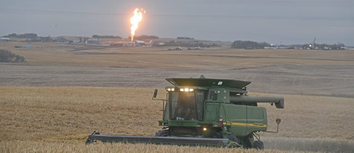  Louis Hannotte combines barley about one kilometre south of the finger of flame from a TransGas pumping station near Prud’Homme, Sask. | William DeKay photo