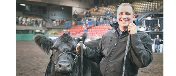 Garth Rancier of Killam, Alta., wins the Supreme Champion Female at Farmfair with a Simmental cow from a winning family. The cow’s family has won three trucks. The cow and calf are co-owned with Westman Land and Cattle Co.| Mary MacArthur photo