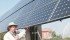 Vern Bretin explains how his large solar powered unit works on his greenhouse near Calgary. His operation is in a good location to take advantage of solar power. | File photo