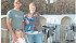 Berend and Karen Ridder, shown with Ella and Jace, are taking over the family dairy at Didsbury, Atla. They milk 130 purebred Holsteins and recently added a calf barn with an automatic feeding system. | Barbara Duckworth photo