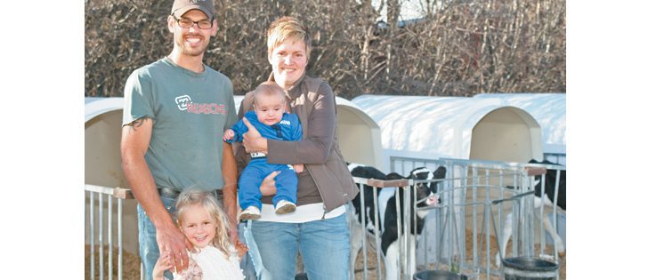 Berend and Karen Ridder, shown with Ella and Jace, are taking over the family dairy at Didsbury, Atla. They milk 130 purebred Holsteins and recently added a calf barn with an automatic feeding system.  |  Barbara Duckworth photo