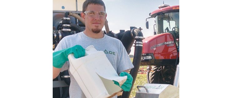 Ethan Eck says the product drops into the handler the moment the jug wall is sliced open, allowing the rotary nozzle to clean inside and outside the container. The original design used three blades to open the jug. It’s available as a retrofit insert for existing poly handler tanks. Some ChemBlade models use a manual lever to pop the knives through the container, while the latest ES uses an air ram to speed things up.  |  Ralph Lagergren photo