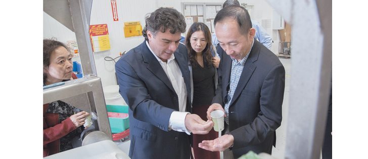 Paul Pereira, left, chief executive officer of Meredian Holdings Group, explains to potential clients how canola oil can be turned into a bioplastic. Meredian has built a bioplastic production plant in Bainbridge, Georgia, and has contracted local farmers to grow canola. Meredian says it cannot satisfy customer demand and will need to rapidly expand its operations, which could involve building plants in Western Canada.  |  the Kidd Group photo