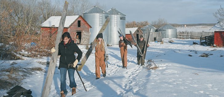 Members of the Marshall family carry corral boards to the on-farm craft shop near Neilburg, Sask. The boards will be recycled into signs and frames. Leading the group is Jo Marshall followed by children Chloe and Wyatt, and husband Trevor. | William DeKay photo