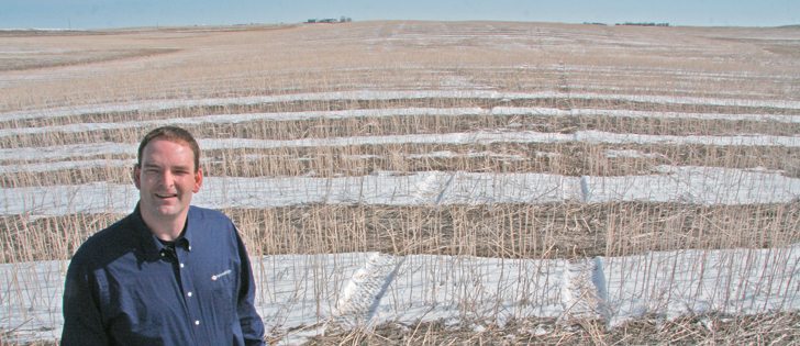 Soil sampling technician Calvin Ruff, with Farmer’s Edge, stands in a field he is sampling near Lethbridge. GPS and satellite imagery enable accuracy in both composite and more comprehensive samples to provide variable rate fertility recommendations.  |  Barb Glen photo