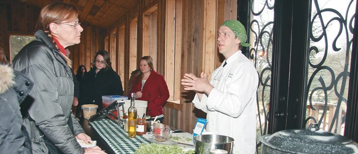 Green Door Gourmet chef Richard Jones teaches visitors how to prepare kale grown on the Tennessee farm.  |  Karen Morrison photo