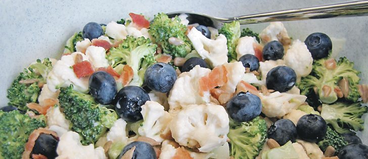 Broccoli cauliflower salad with fresh blueberries is an easy to transport salad for a picnic. For food safety, pack the bacon separate and keep on ice, then add just before serving. Keep the salad in a cooler until just ready to serve and return any leftovers to the cooler as soon as the meal is over. When on the picnic table, place an ice pack under the salad to keep it cool.  |  Betty Ann Deobald photo