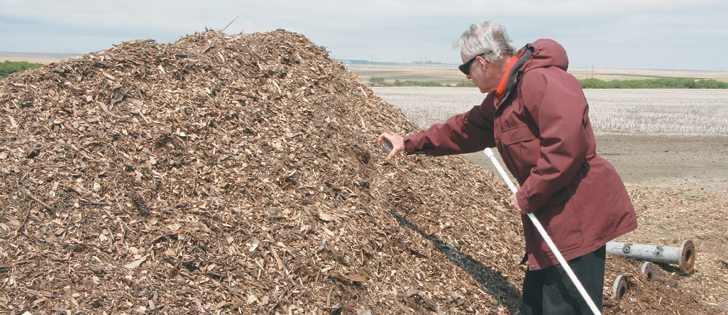 Larry Mullen of the Saskatchewan Waste Reduction Council places a temperature probe in a static compost pile at PV Waste Solutions near Regina.  |  Karen Briere photo