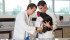 A rooster who lost his feet to frostbite wears prosthetic legs designed
by engineering student Doug Kondro, left. Kondro worked with Daniel Pang, right, a professor in the Faculty of Veterinary Medicine, on the project. | University of Calgary photo