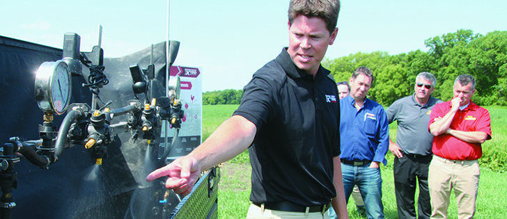 Allan Froese, technology development rep with Monsanto Canada, demonstrates nozzle options at a field day in Oakville, Man. in late June. Froese and other Monsanto staff shared details of the company’s Roundup Ready Xtend technology, a new trait for soybeans where the crop is tolerant of glyphosate and dicamba  |  Robert Arnason photo