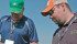 Pioneer representatives Doug Moisey, left, and Myroslav Zukiwski examine corn plants in the test plots next to Dupont Pioneer’s new research facility east of Lethbridge. | Barb Glen photo