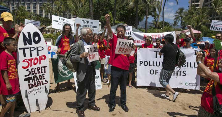 Former Japanese Agriculture Minister Masachiko Yamada (C) leads a protest against the Trans-Pacific Partnership meeting (TPP) in Lahaina, Maui, Hawaii July 29, 2015. Pacific Rim officials meet in Hawaii this week for talks that could make or break an ambitious trade deal which aims to boost growth and set common standards across a dozen economies ranging from the United States to Brunei.  Protesters formed on the beach this afternoon in front of the hotel where the TPP meetings are being held.  REUTERS/Marco Garcia 