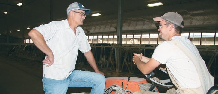 Blaine McLeod, a longtime dairy operator at Caronport, Sask., chats with his son, Michael.  |  Karen Morrison photo