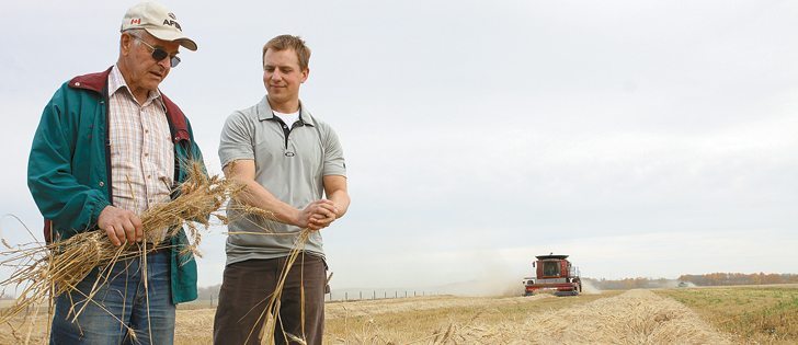 Terry Gabert, left, and Brett Jans check out the CPS wheat during the harvest.
|  Mary MacArthur photo