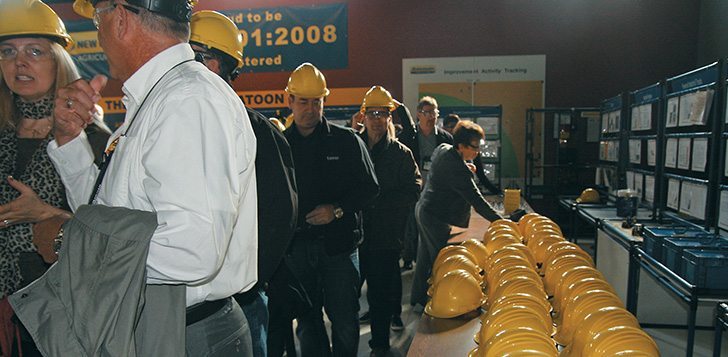 Canadian Agricultural Safety Association delegates don safety helmets for a tour of the CNH Industrial plant in Saskatoon Oct 8.   |  Ashley Robinson photo