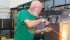 Joan and Alan Hiebert are known for their recycled glass creations. Using specialized machines, Alan demonstrates how the glass blowing rod is used to heat and shape glass in his hot shop near Dundurn, Sask. Joan also teaches others the art of glass blowing. | Karen Morrison photo
