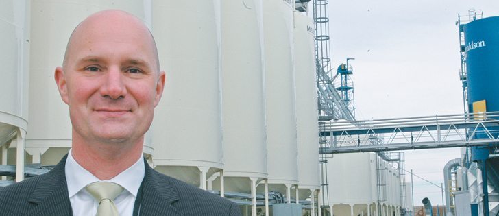 Marcus Weidler, head of Bayer CropScience Canada, stands in front of the newly expanded Lethbridge canola seed cleaning plant said to be the largest in the world.  |  Barb Glen photo
