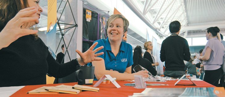 Cheryl Loewen, left, and Trudy Elgersma chat while awaiting visitors to the UFA booth Sept. 30 during the University of Lethbridge career fair.  |  Barb Glen photo