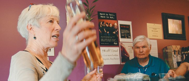 Cherie Andrews of Chinook Honey Co. and Chinook Arch Meadery pours samples of mead for members of a visiting tour group Sept. 25 at the operation’s shop near Okotoks, Alta. | Barb Glen photo
