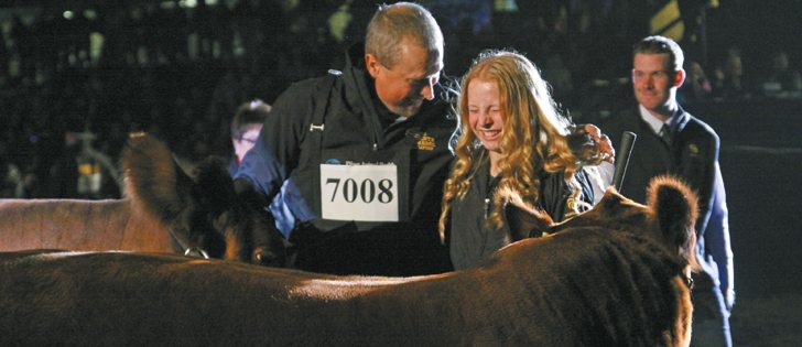 Rob and Halley Adams share a moment of joy as their Red Angus cow and calf are declared winners at the supreme show at Edmonton’s Farmfair. The cow was Halley’s 4-H project for three years. The Dietrich family won the supreme champion bull class.  |  Mary MacArthur photo