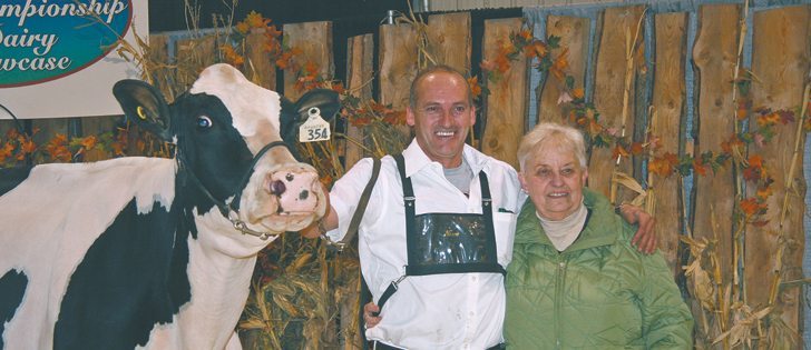 Marjorie Atkins is congratulated by Christian Roberge. This mature cow named Lakefield Dundee Janice was the grand champion of the Westerner Dairy Showcase Holstein Show. Marjorie and her husband Norman Atkins own Continental Holsteins at Leduc, Alta.
|  Barbara Duckworth photo