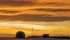 Farm buildings are silhouetted by the setting sun under a western chinook arch west of Milo, Alta. Although these stratus clouds look like storm clouds, they rarely produce rain or snow. They do, however, produce stunning colours, appearing yellow, orange or red in the morning, becoming grey through the day and again turning a brilliant orange/yellow at sunset. | Mike Sturk photo