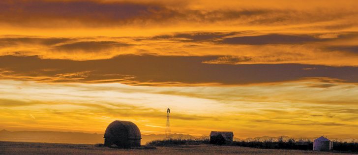 Farm buildings are silhouetted by the setting sun under a western chinook arch west of Milo, Alta. Although these stratus clouds look like storm clouds, they rarely produce rain or snow. They do, however, produce stunning colours, appearing yellow, orange or red in the morning, becoming grey through the day and again turning a brilliant orange/yellow at sunset.   |  Mike Sturk photo