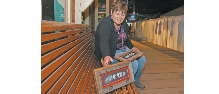 Lucille Scott mounts and frames her painted feathers on old barn boards.  |  Karen Morrison photo