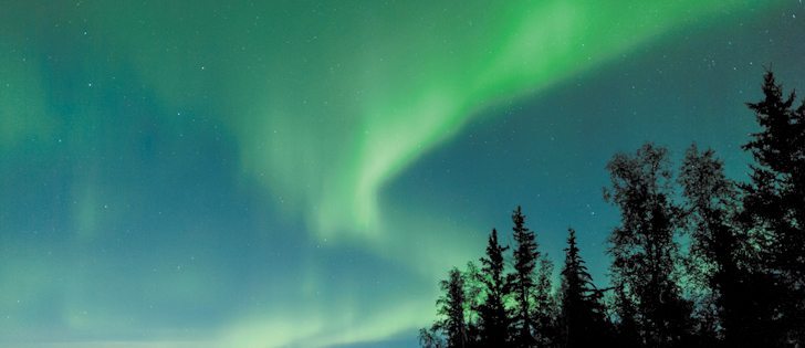 Visible aurora occur when particles in the ionosphere are struck by energetic particles that originate from the sun. These collisions generate light, making the aurora borealis.