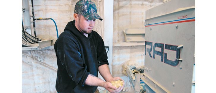 Western Soybean Co. operations manager Mike Parsons holds a handful of meal that has come through the process.  |  Barb Glen photo