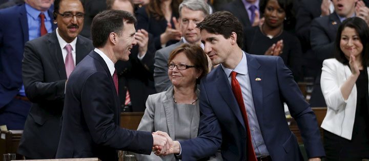 Canada's Prime Minister Justin Trudeau shakes hands with Finance Minister Bill Morneau after delivering the federal budget in the House of Commons on Parliament Hill in Ottawa.  |  REUTERS/Chris Wattie