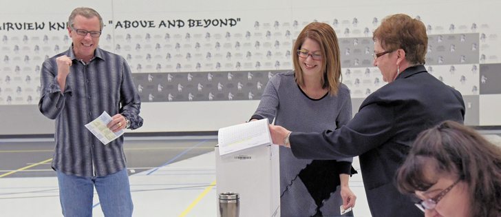 Saskatchewan Party leader Brad Wall, left, seemed in a good mood as he cast his ballot on the morning of April 4. It later proved he had good reason to be optimistic. By the end of the night, the Sask. Party would win its third majority government.  |  William DeKay photo