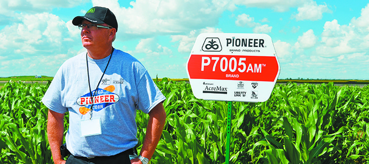 Ellis Clayton, technical product manager of DuPont Pioneer Canada, stands in front of corn trials conducted at the company’s research centre near Saskatoon.  |  Tennessa Wild Photo