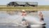 Cousins Grady and Cody Keith surf and wake skate over a low spot in a neighbour’s canola field near Sovereign, Sask., Aug. 16. Too much rain this year has played havoc with crops in many parts of the Prairies. | William DeKay photo