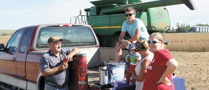 A combining crew at 4g Wild Farms Ltd. from Rivercourse, Alta., takes a short break for coffee and a snack. Harvest operations across much of northwestern Saskatchewan and northeastern Alberta are a week to 10 days ahead of normal. | Brian Cross photo