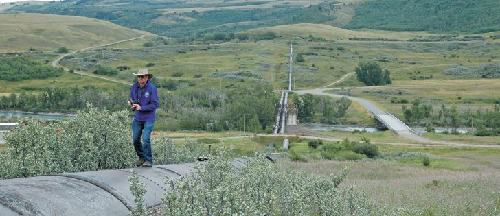 William King of Milk River, Alta., walks along one of the siphons that carry water over the St. Mary River into the Milk. One of the two siphons was built in 1912-15 and the other in 1925-26. Both are considered a critical part of water infrastructure affecting both Canadian and American water users.  |  Barb Glen photo