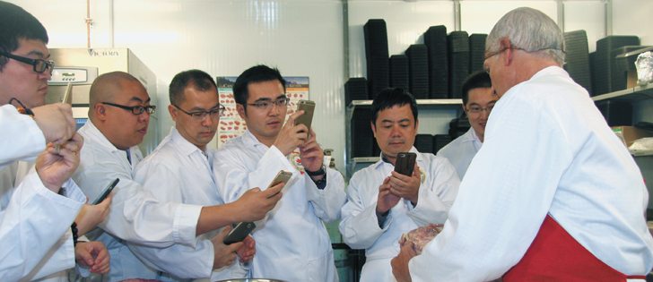 Abe Van Melle, right, technical director at the Canada Beef Centre of Excellence, demonstrates meat cutting techniques for a Chinese delegation visiting Calgary Aug. 1-6. Dealing with today’s carcasses, which are larger than in the past, and new ways of cutting beef 
to get more value were shown.  |  Barbara Duckworth photo