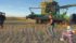 Hayden Grunerud, 10, and her five-year-old sister, Emma, follow Norman Ballek to his combine for a few circuits around the canola field south of Broderick, Sask., Sept. 14. | William DeKay photo