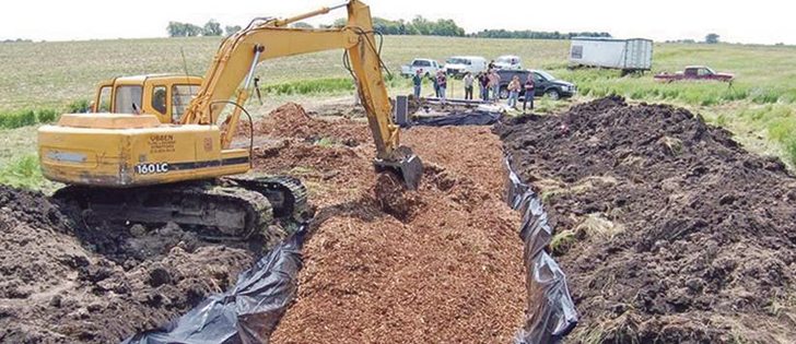 A bioreactor is installed in an Iowa Soybean Association project in Iowa’s Hamilton County. Wood chips form the filter in the system. |  Laura Christianson photo