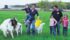 Anna Haupt and Mark McCutcheon walk through the field with their children, Anya, Helaina and Eve, to check on their buck and doe. | Sharon Grose photo