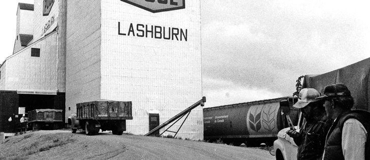 Charles Townley-Smith and Greg Cressman wait their turn to deliver grain at the Saskatchewan Wheat Pool elevator in Lashburn, Sask.,
in this undated photo.  |  File photo