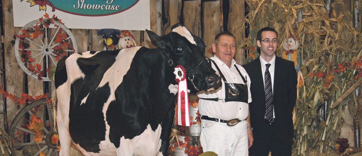 Orville Schmidt, left, and judge Joel Lepage stand with Tolamika Goldwyn Mercedes, which was grand champion Holstein at the Red Deer Westerner Dairy Showcase.  |  Barbara Duckworth photo